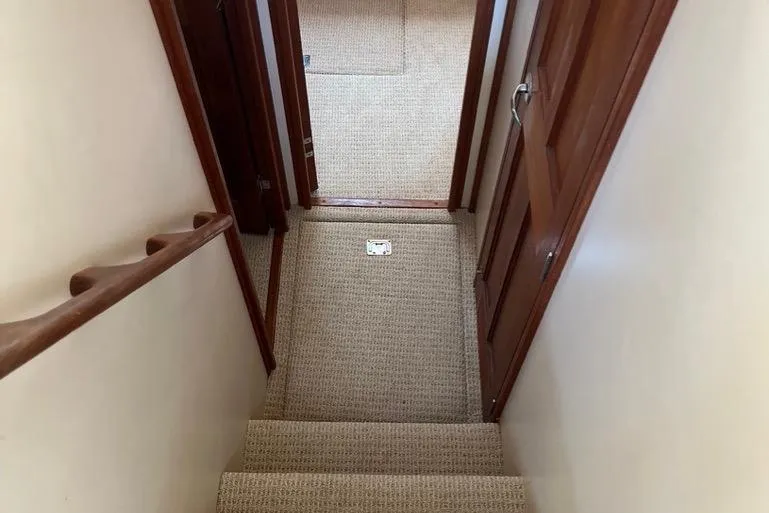 Egret Yacht Photos Pics Stairway inside 2005 Nordic Tug 37 Flybridge with carpeted steps and wooden handrails.