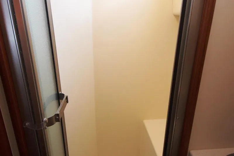 Egret Yacht Photos Pics Shower area inside 2005 Nordic Tug 37 Flybridge boat, featuring a glass door.