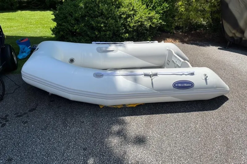 Egret Yacht Photos Pics Inflatable West Marine dinghy on pavement, surrounded by greenery. Nordic Tug 37 Flybridge, 2005.