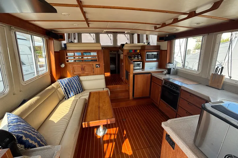 Egret Yacht Photos Pics Interior of 2005 Nordic Tug 37 Flybridge with kitchen and seating area.
