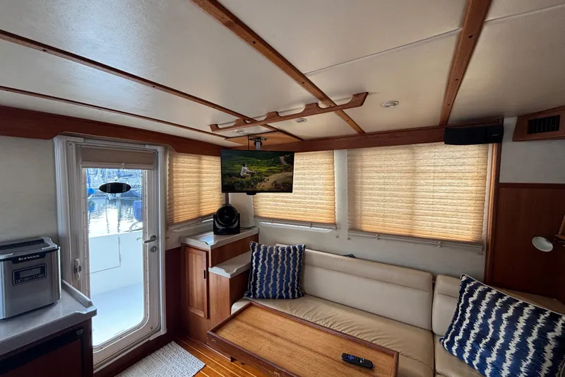 Egret Yacht Photos Pics Interior of 2005 Nordic Tug 37 Flybridge with cozy seating and modern amenities.