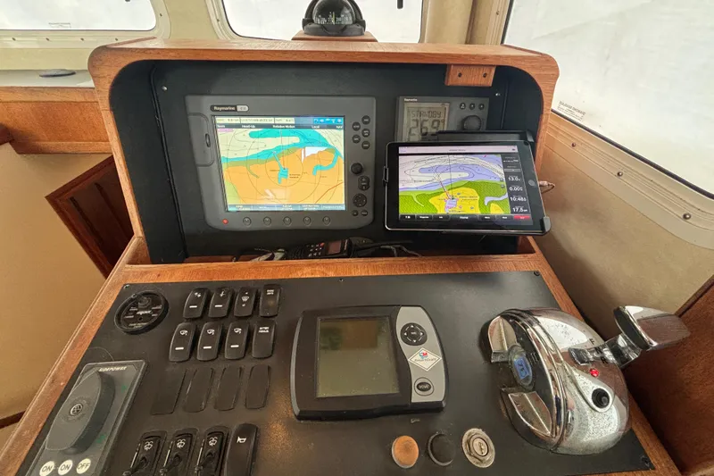 Egret Yacht Photos Pics Navigation equipment on 2005 Nordic Tug 37 Flybridge, featuring GPS and control panel.
