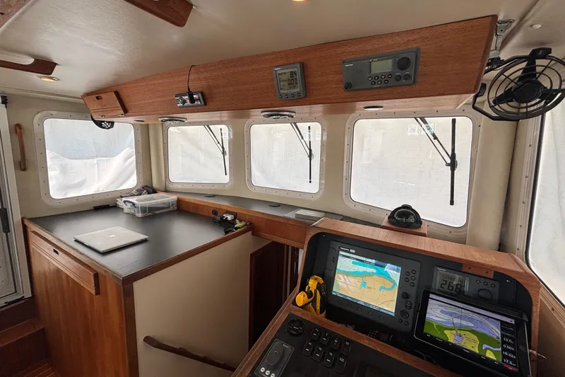Egret Yacht Photos Pics Pilothouse of 2005 Nordic Tug 37 Flybridge with navigation equipment and wooden cabinetry.