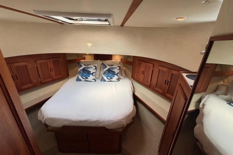 Egret Yacht Photos Pics Cozy cabin interior of 2005 Nordic Tug 37 Flybridge with wooden cabinets and nautical decor.