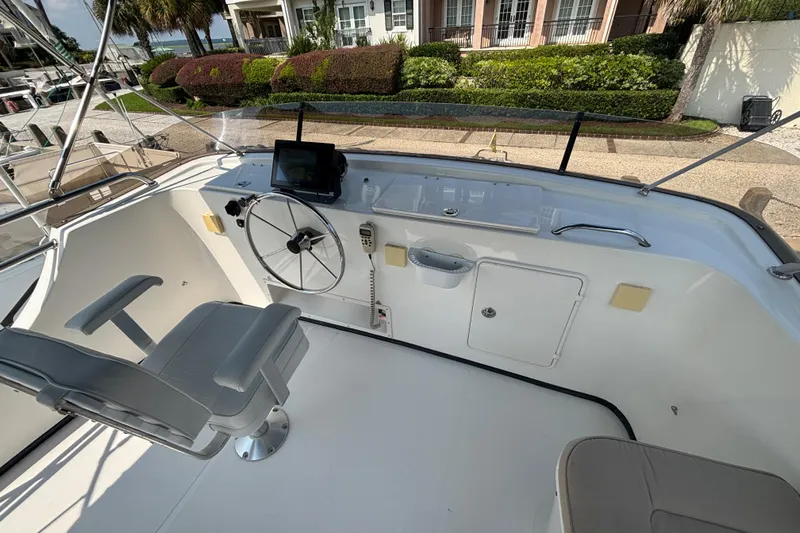 Egret Yacht Photos Pics Upper Helm on 2005 Nordic Tug 37 Flybridge with centerline armchair Captains seat and collapsable electronics panels that lower into helm console.