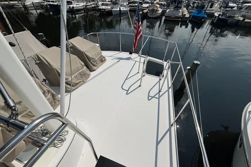 Egret Yacht Photos Pics Aft Deck on 2005 Nordic Tug 37 Flybridge featuring deck chairs, space for dingy and stainless steel railing