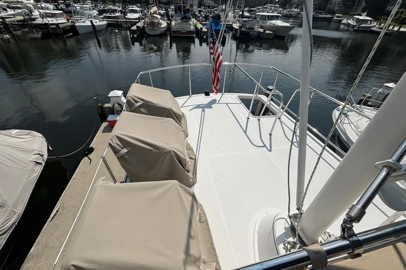 Egret Yacht Photos Pics Aft Deck on 2005 Nordic Tug 37 Flybridge featuring deck chairs, space for dingy and hinged mast with boom
