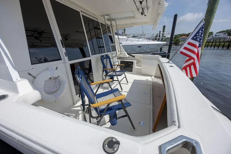  Yacht Photos Pics 2008 Meridian 490 Pilothouse yacht deck with chairs and American flag.