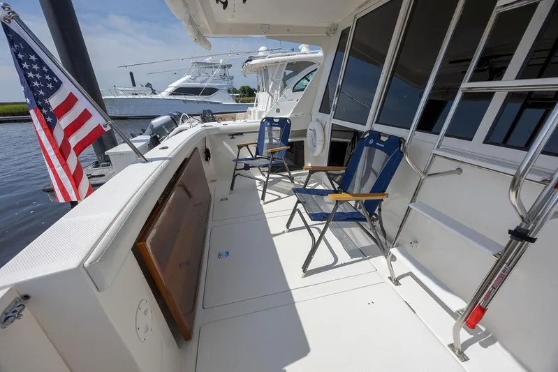  Yacht Photos Pics 2008 Meridian 490 Pilothouse yacht deck with chairs and American flag.