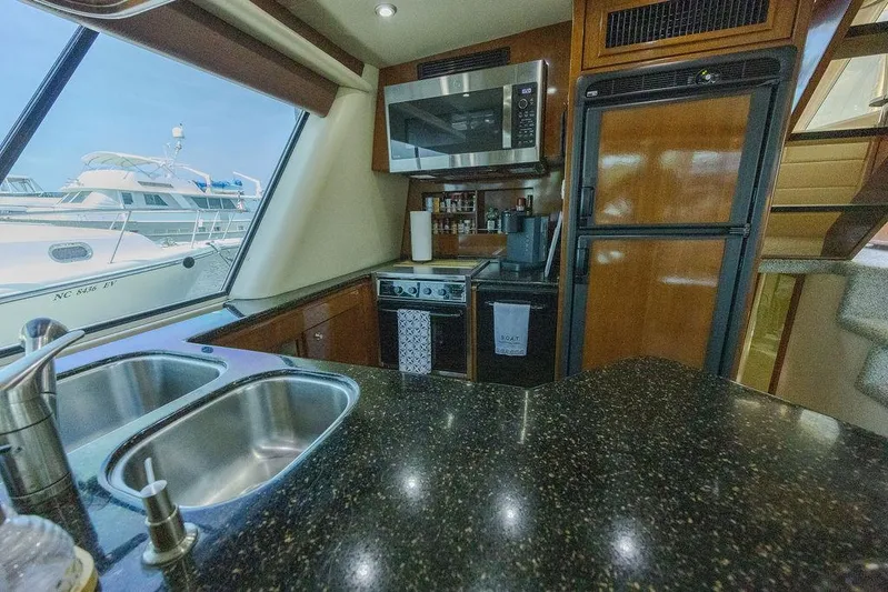  Yacht Photos Pics Luxurious kitchen interior of 2008 Meridian 490 Pilothouse yacht with modern appliances.
