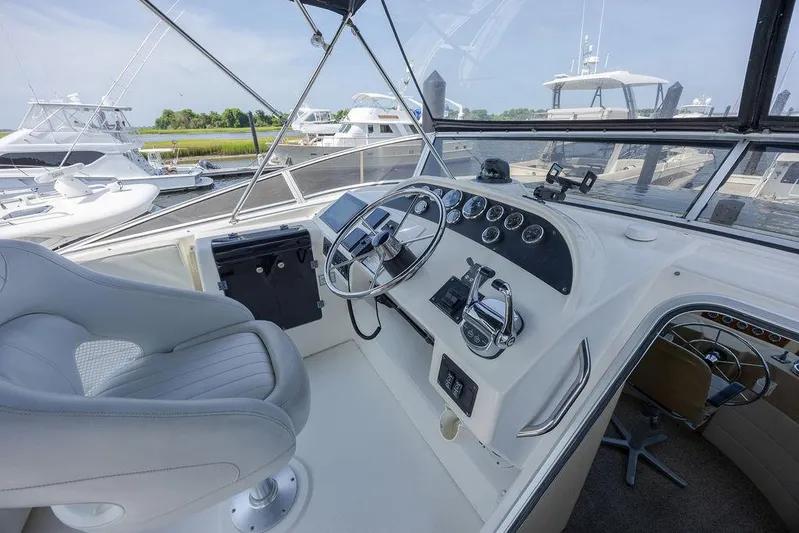  Yacht Photos Pics Pilothouse interior of 2008 Meridian 490, featuring steering wheel and control panel.