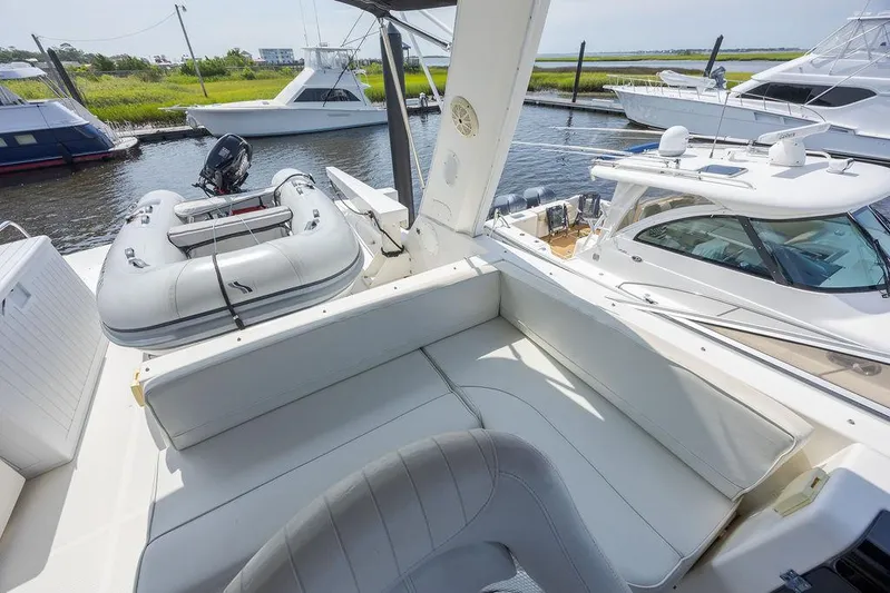  Yacht Photos Pics 2008 Meridian 490 Pilothouse yacht with inflatable dinghy, docked in a marina.