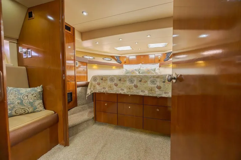  Yacht Photos Pics Luxurious 2008 Meridian 490 Pilothouse bedroom with elegant wood finishes and cozy bedding.