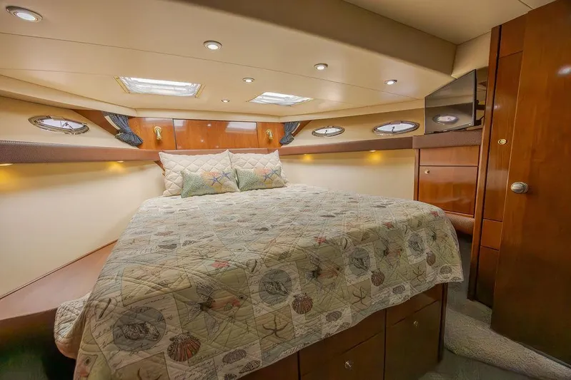  Yacht Photos Pics Luxurious cabin interior of 2008 Meridian 490 Pilothouse yacht with cozy bed and elegant wood finish.