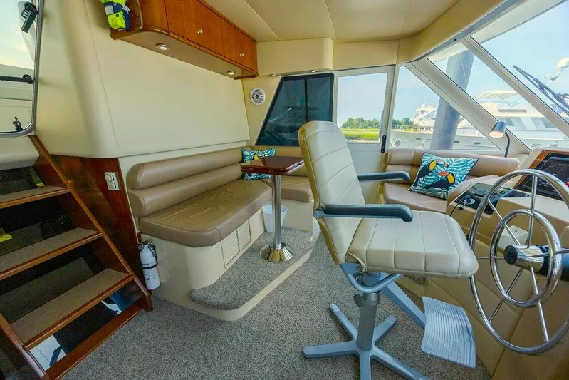  Yacht Photos Pics Interior of 2008 Meridian 490 Pilothouse with seating, steering wheel, and large windows.