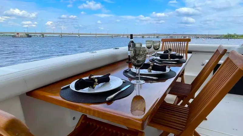  Yacht Photos Pics Elegant dining setup on 2008 Meridian 490 Pilothouse yacht with scenic water view.