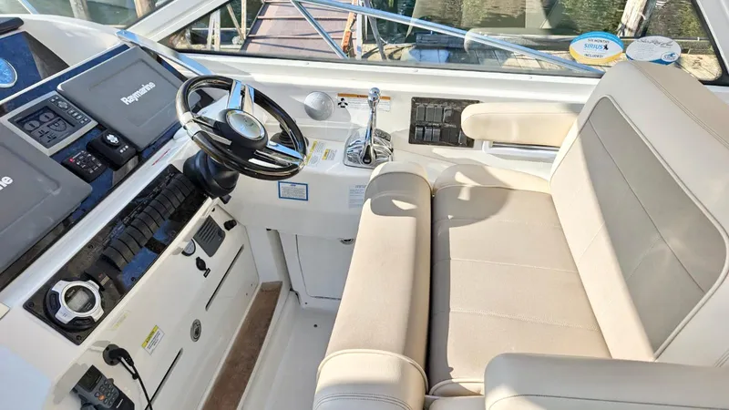  Yacht Photos Pics 2012 Sea Ray 450 Sundancer helm with steering wheel and navigation controls.