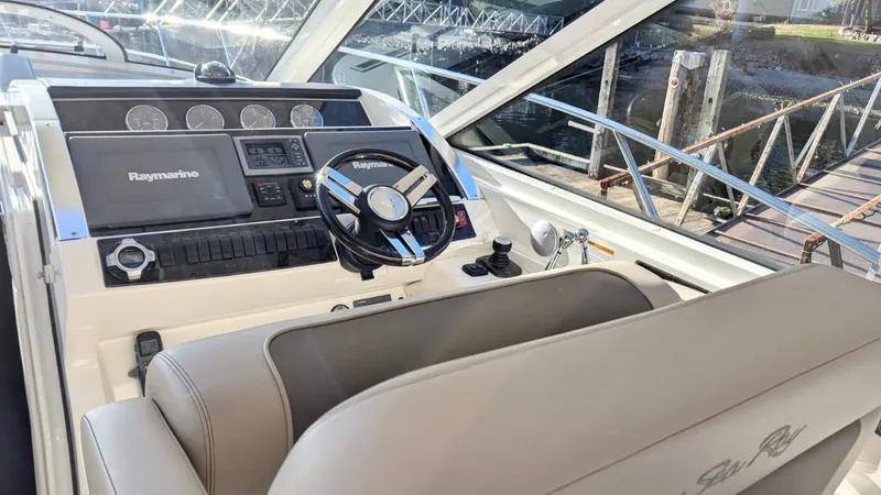  Yacht Photos Pics Helm of 2012 Sea Ray 450 Sundancer with Raymarine electronics and leather seating.