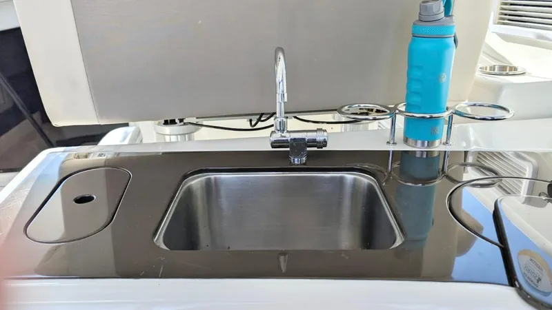  Yacht Photos Pics Stainless steel sink on 2012 Sea Ray 450 Sundancer yacht with blue water bottle.
