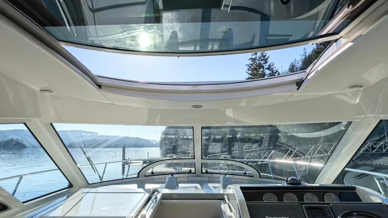  Yacht Photos Pics Interior view of 2012 Sea Ray 450 Sundancer yacht with panoramic windows and scenic water backdrop.
