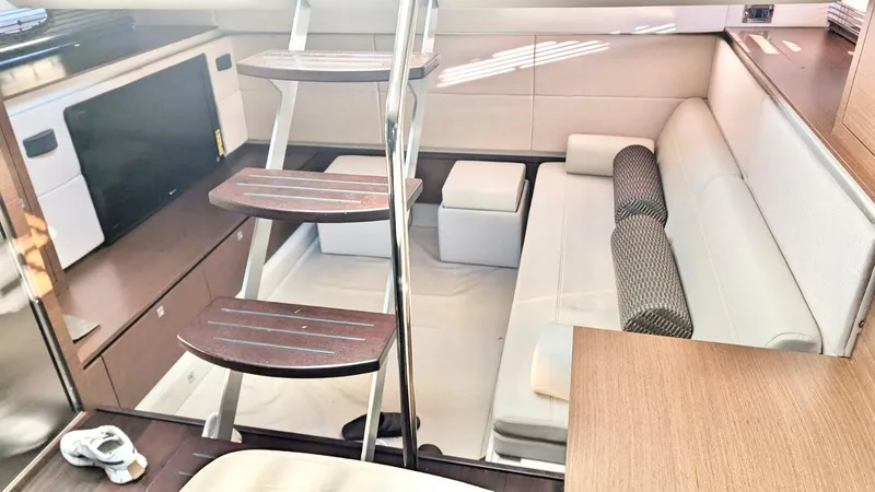  Yacht Photos Pics Interior of 2012 Sea Ray 450 Sundancer yacht, featuring modern seating and wooden stairs.