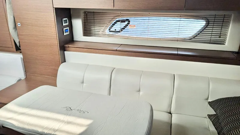  Yacht Photos Pics Interior of 2012 Sea Ray 450 Sundancer yacht with white leather seating and wooden accents.