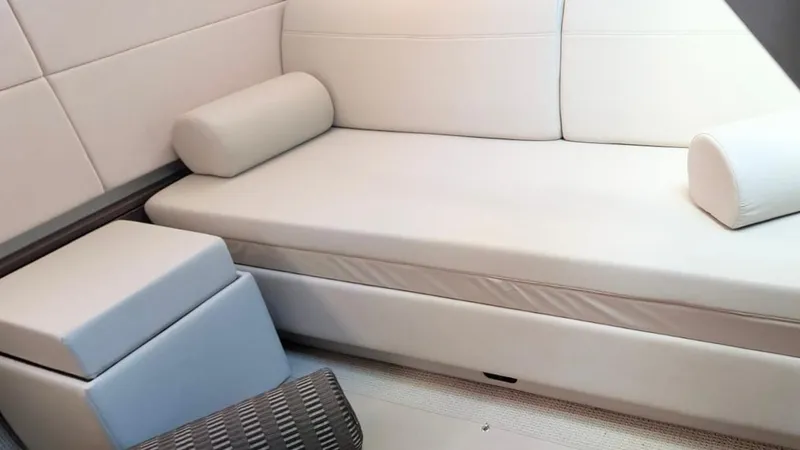  Yacht Photos Pics Luxurious interior of 2012 Sea Ray 450 Sundancer with white seating and cushions.