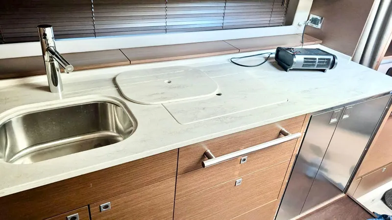  Yacht Photos Pics Modern kitchen area in a 2012 Sea Ray 450 Sundancer yacht with sink and appliances.