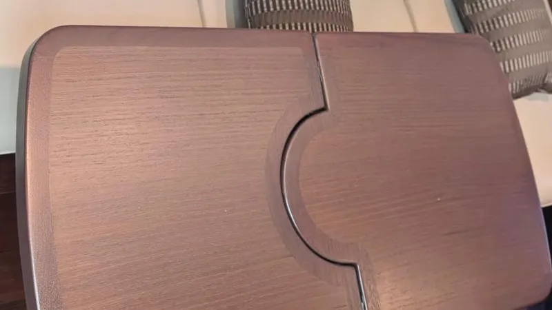  Yacht Photos Pics Wooden table on a 2012 Sea Ray 450 Sundancer yacht, with cushioned seating.