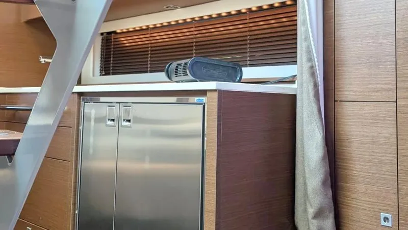  Yacht Photos Pics Interior of 2012 Sea Ray 450 Sundancer with stainless steel fridge and wooden cabinetry.