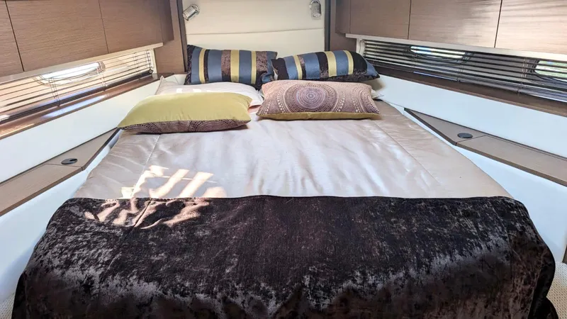  Yacht Photos Pics Luxurious bedroom interior of 2012 Sea Ray 450 Sundancer yacht with elegant bedding.