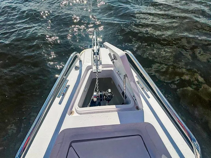  Yacht Photos Pics Bow view of 2022 Axopar 28 CABIN boat with anchor compartment open.