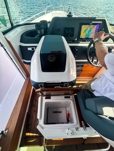  Yacht Photos Pics 2022 Axopar 28 CABIN interior with navigation system and Simrad equipment on open water.
