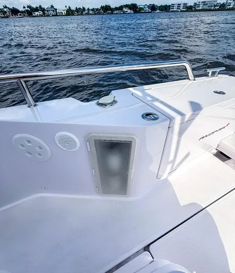  Yacht Photos Pics 2022 Axopar 28 CABIN boat deck with railing, on calm water.