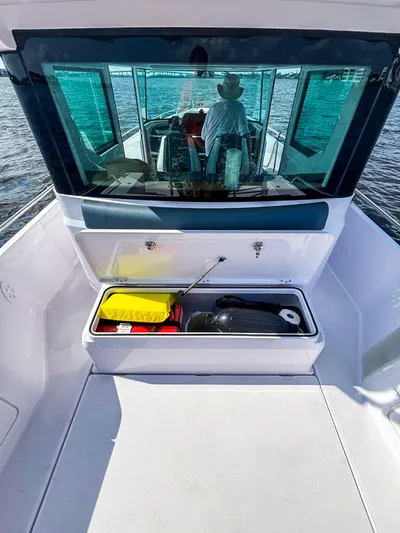 Yacht Photos Pics 2022 Axopar 28 CABIN boat with open storage compartment on deck.
