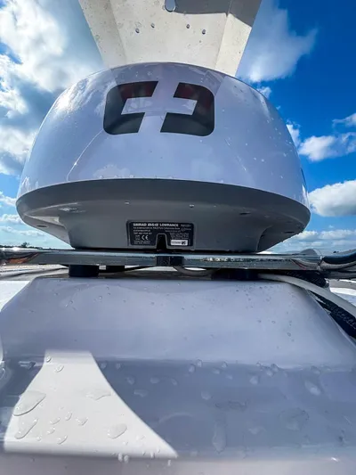  Yacht Photos Pics 2022 Axopar 28 CABIN boat radar against a bright blue sky.