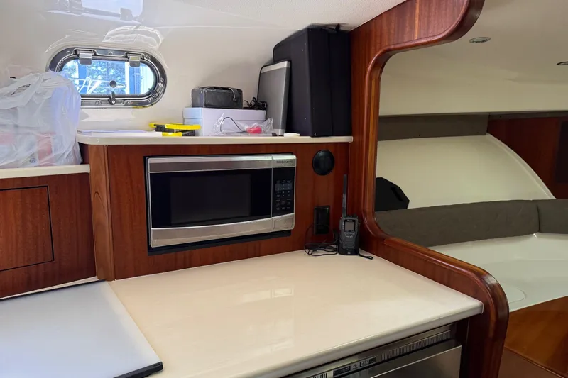  Yacht Photos Pics 2015 Pursuit OS 385 Offshore interior with microwave, countertop, and window.