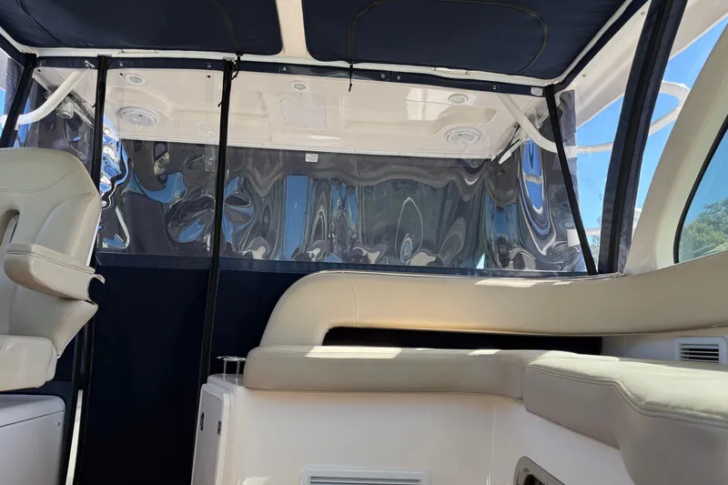  Yacht Photos Pics 2015 Pursuit OS 385 Offshore boat interior with seating and canopy.