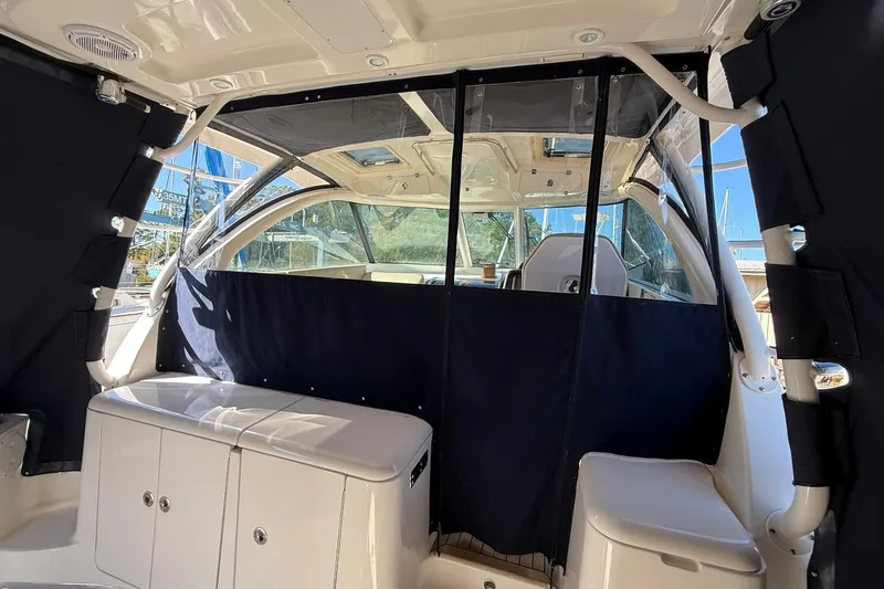  Yacht Photos Pics 2015 Pursuit OS 385 Offshore boat interior with seating and covered windows.