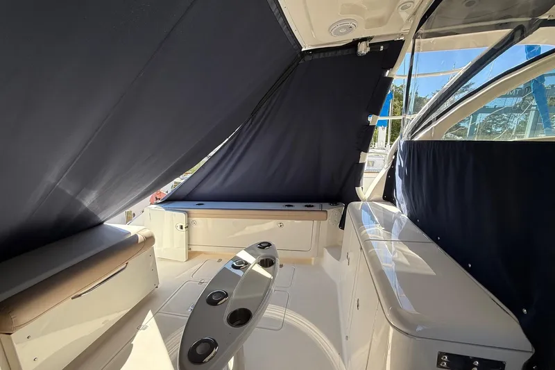  Yacht Photos Pics 2015 Pursuit OS 385 Offshore boat interior with seating and covered windows.