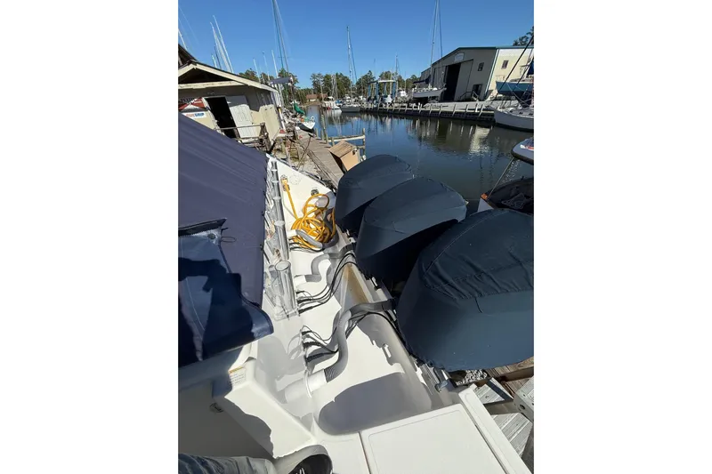  Yacht Photos Pics 2015 Pursuit OS 385 Offshore boat docked, featuring covered engines and marina view.