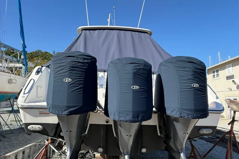  Yacht Photos Pics 2015 Pursuit OS 385 Offshore boat with covered outboard motors, docked outdoors.