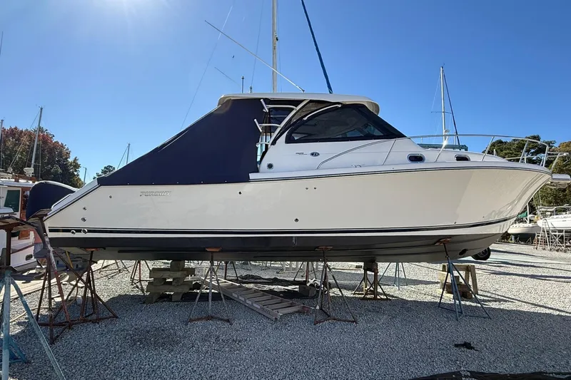  Yacht Photos Pics 2015 Pursuit OS 385 Offshore boat on stands, displayed outdoors under clear blue sky.