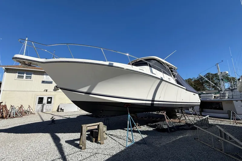  Yacht Photos Pics 2015 Pursuit OS 385 Offshore boat on stands in a marina yard.