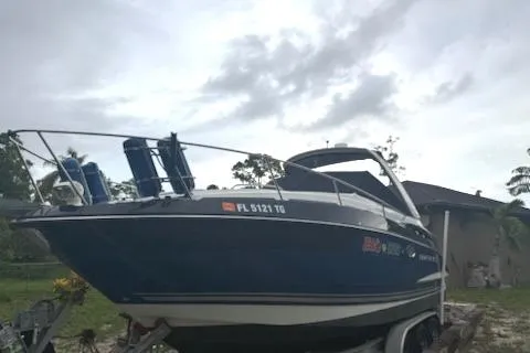  Yacht Photos Pics 2019 Monterey 295 Sport Yacht on trailer, parked outdoors under cloudy sky.