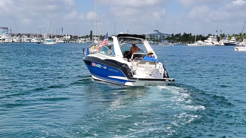  Yacht Photos Pics 2019 Monterey 295 Sport Yacht cruising in a marina with clear blue skies.