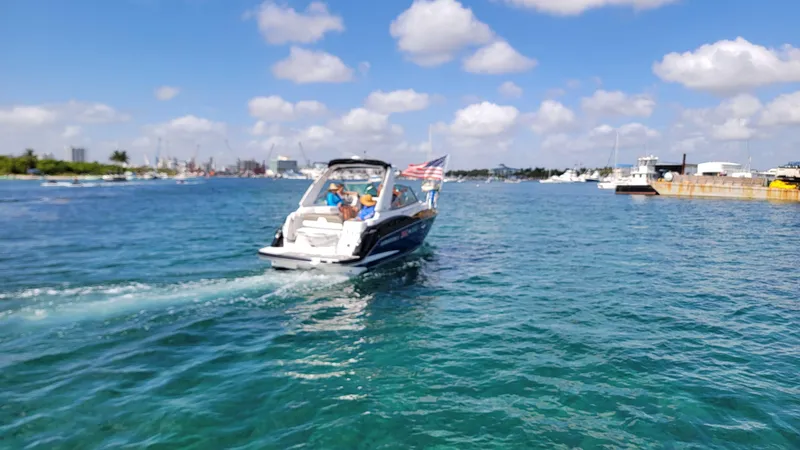  Yacht Photos Pics 2019 Monterey 295 Sport Yacht cruising on a sunny day with American flag.
