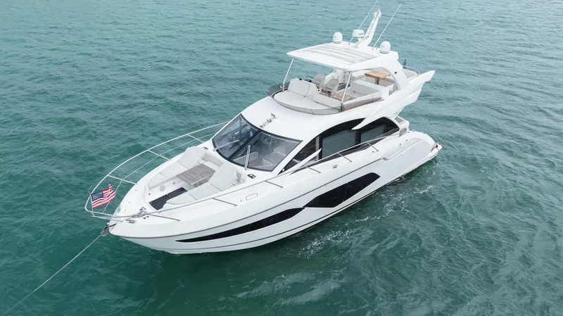 Why Knot Yacht Photos Pics Luxurious 2020 Sunseeker 52 Manhattan yacht cruising on open water.