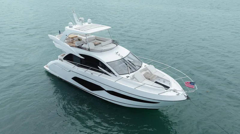 Why Knot Yacht Photos Pics Luxurious 2020 Sunseeker 52 Manhattan yacht cruising on calm blue waters.