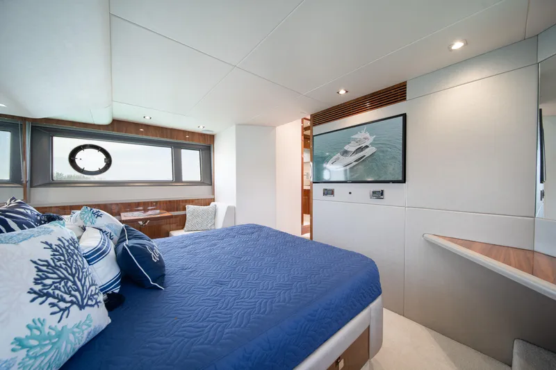 Why Knot Yacht Photos Pics Luxurious bedroom interior of 2020 Sunseeker 52 Manhattan yacht with elegant decor.